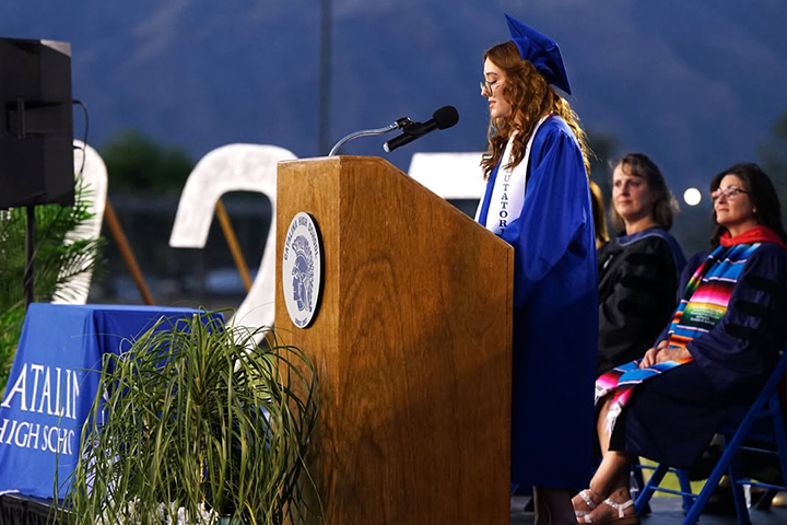 A graduate addresses her class