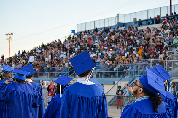 Graduates process into the stadium