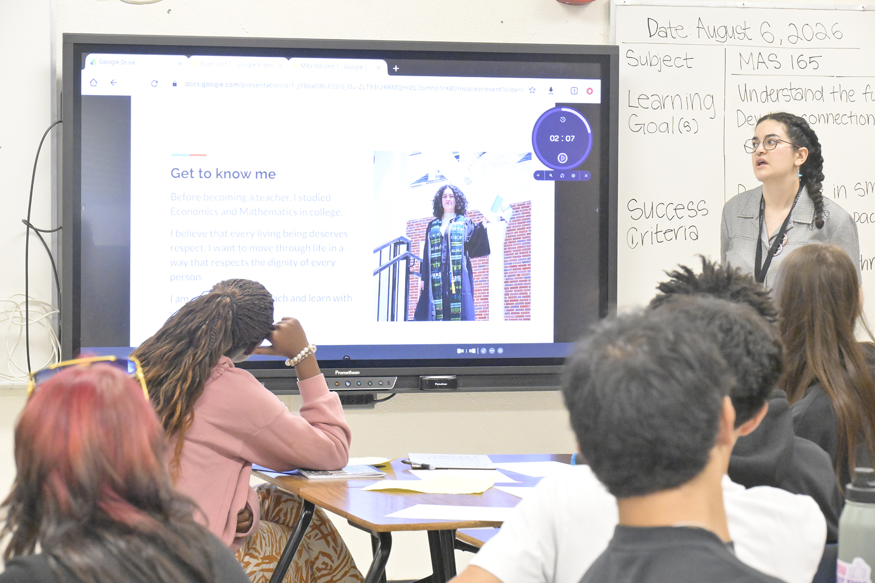 A teacher talks to her students